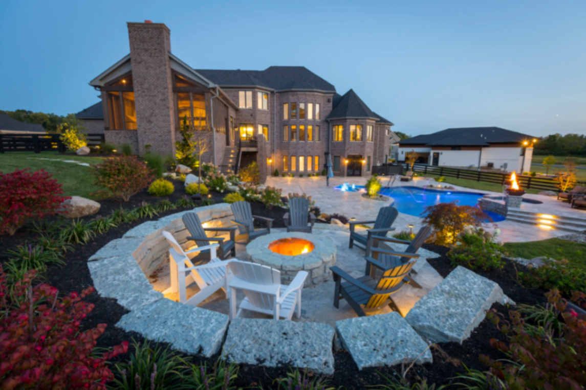 Manicured lawn with natural stone retaining wall and mature landscape plantings