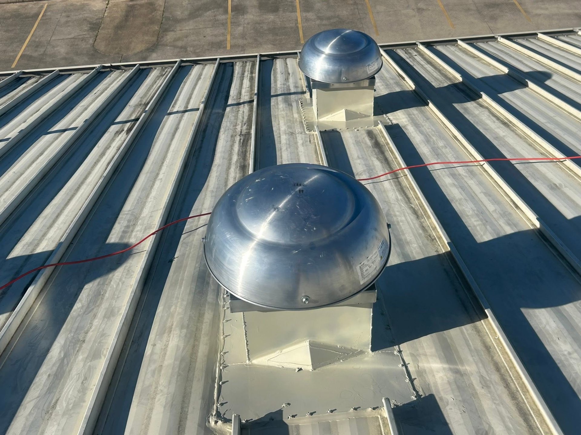 Roof-mounted turbine vents on a standing-seam metal commercial roof