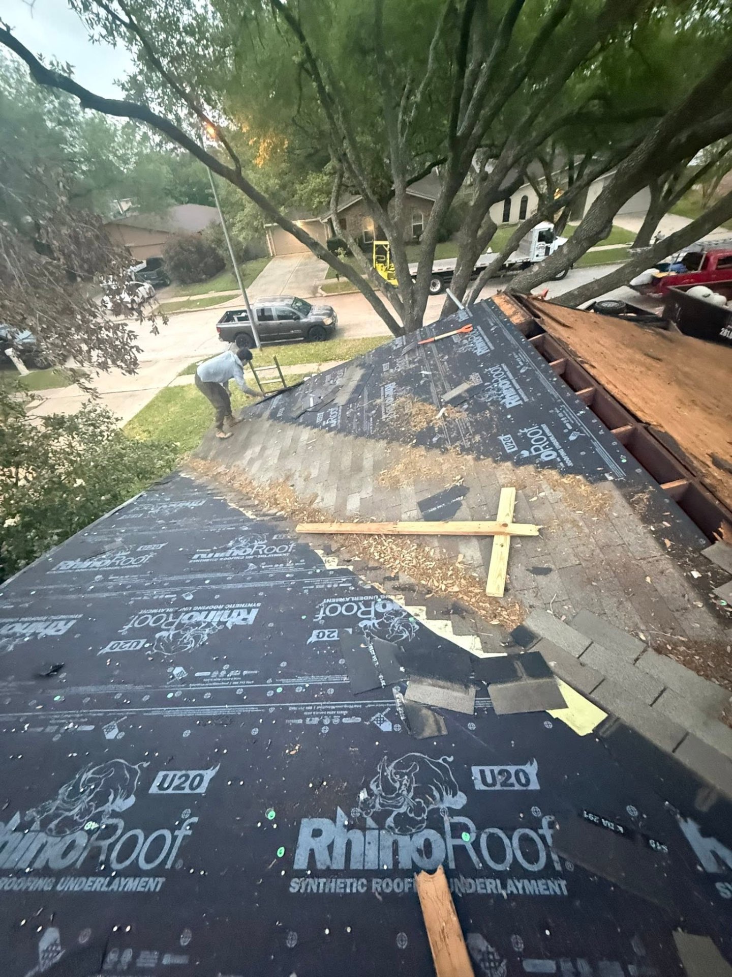 RhinoRoof synthetic underlayment installed on a deck mid-tear-off