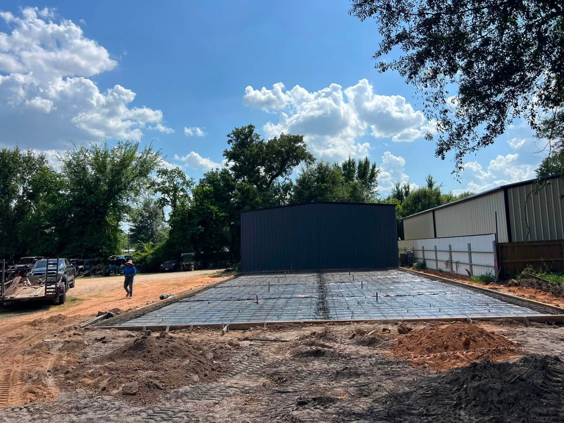 Metal shop building with a freshly poured rebar-reinforced foundation slab