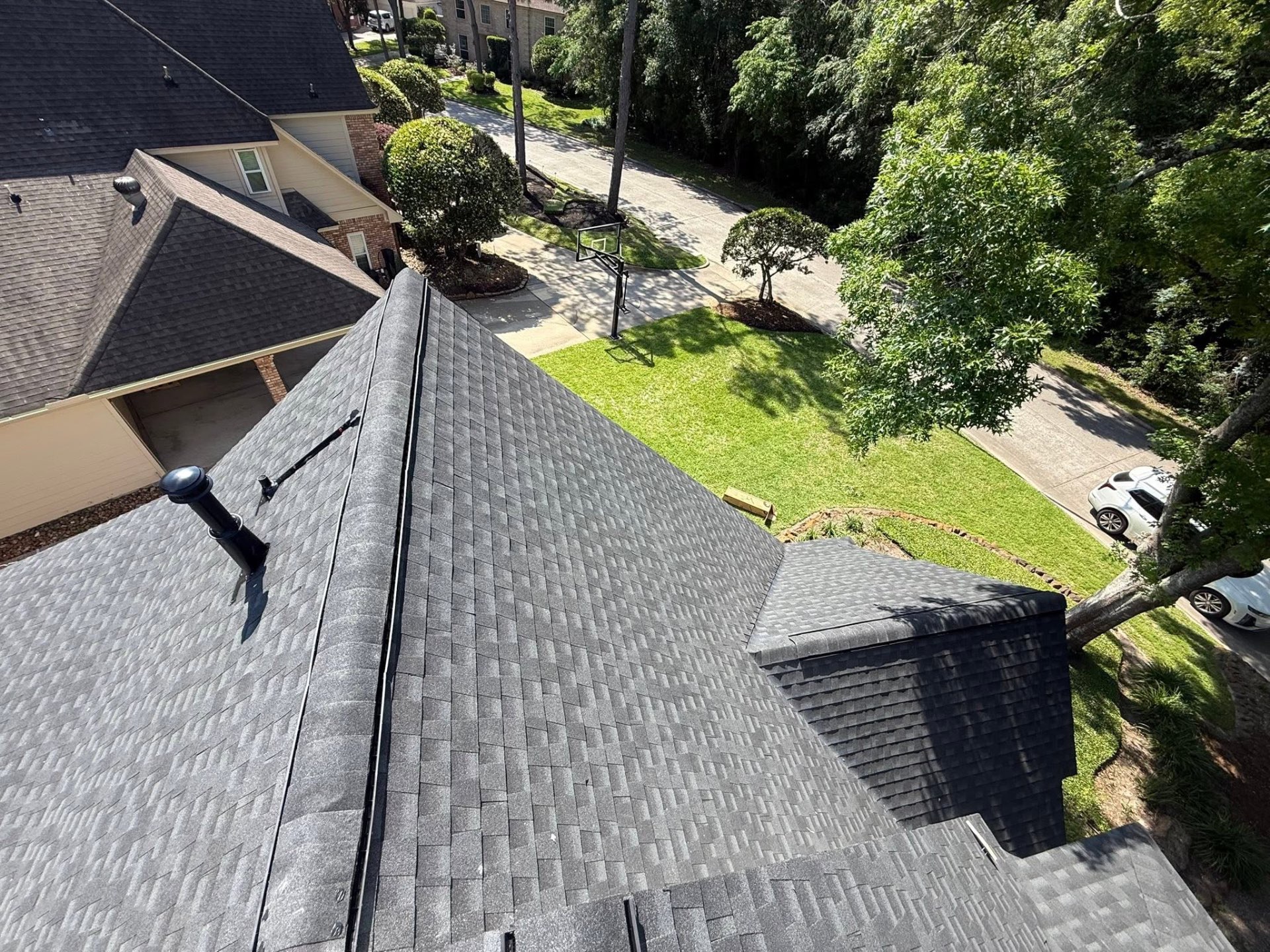Ridge-line detail on a completed gray shingle roof