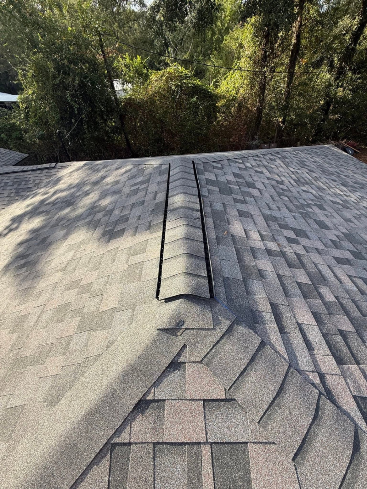 Close-up of ridge vent installation on architectural shingles